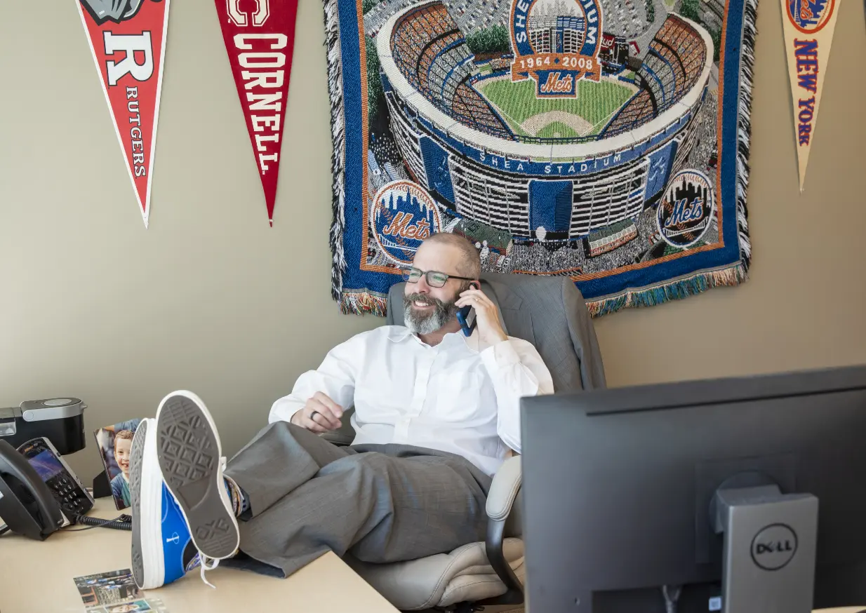 Phia employee showing off Phia branded converse while taking a call