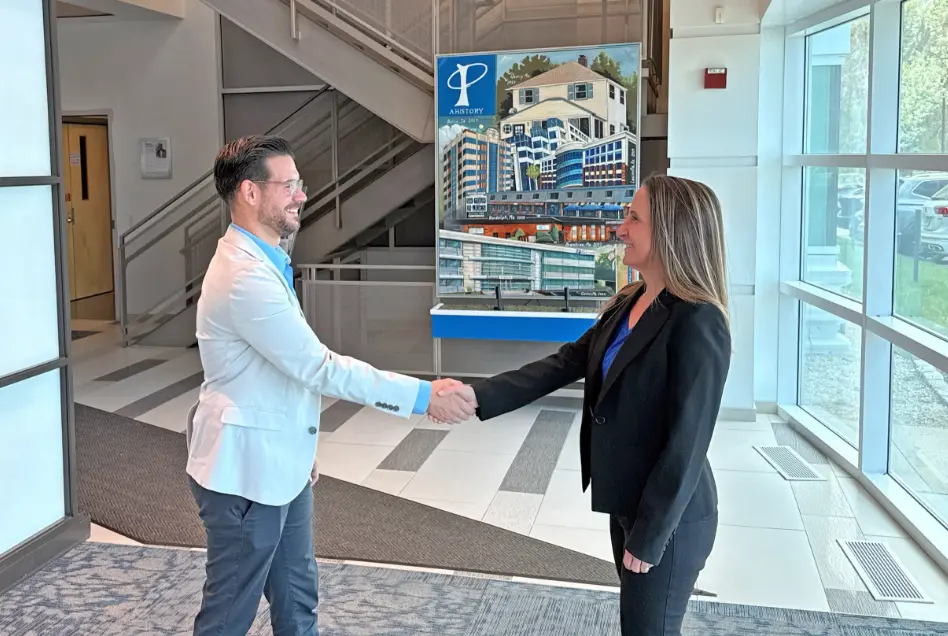shake Employees of The Phia Group shaking hands in lobby.